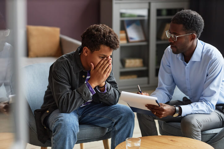 Crisis response and mental health training graduate offering support to young male