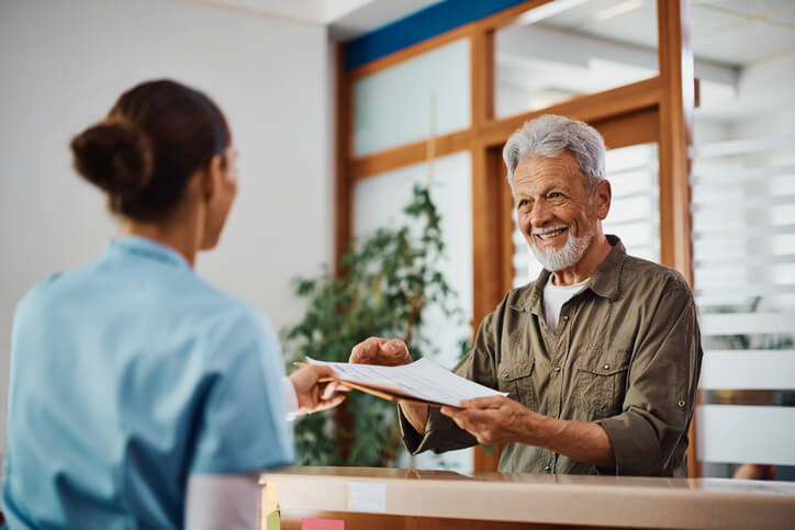 medical office management training grad helping a patient