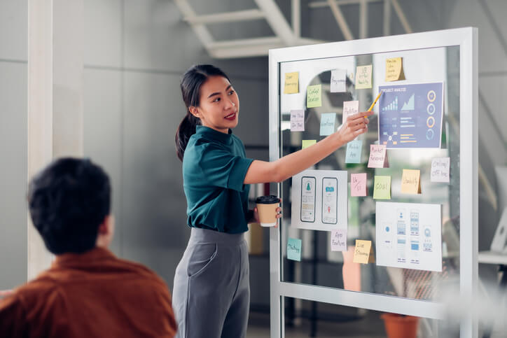 An office management training grad doing a presentation for her team