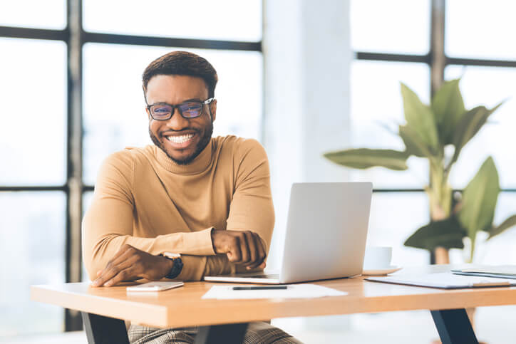 A smiling male digital marketing professional working from home after digital marketing training