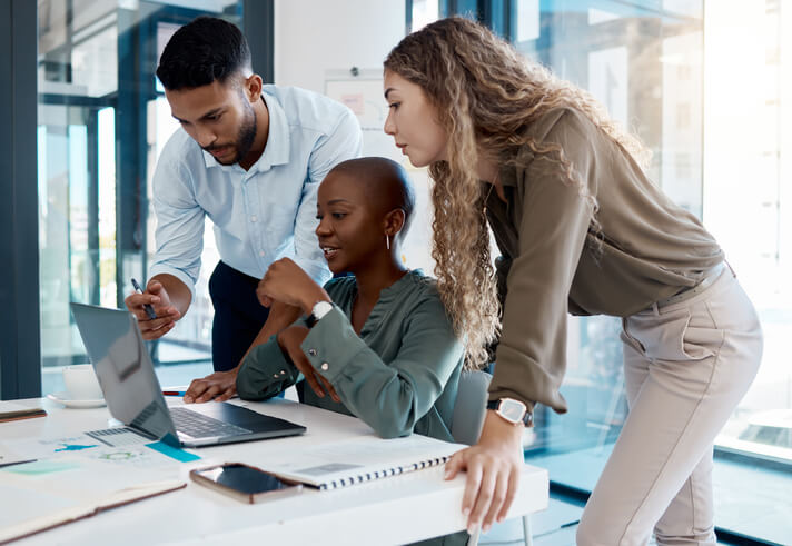 A team of focused digital marketing professionals working in an office after their digital marketing training