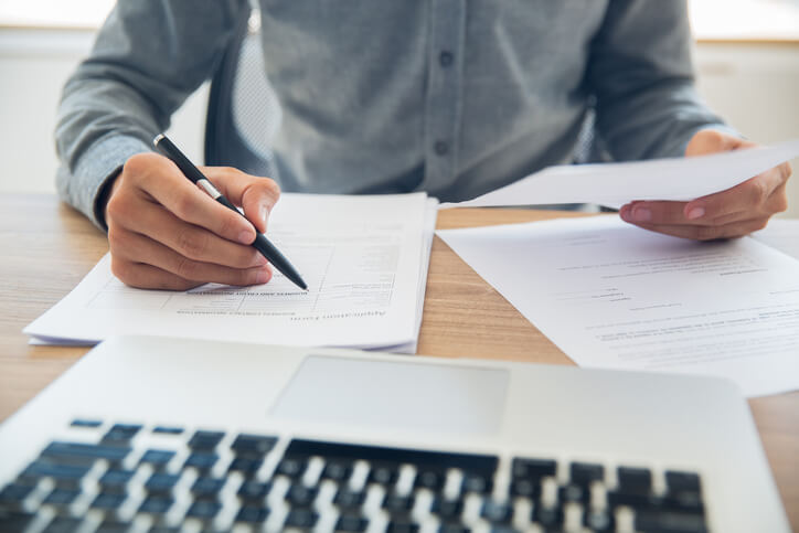 A focused business professional checking documents after completing his international trade management training