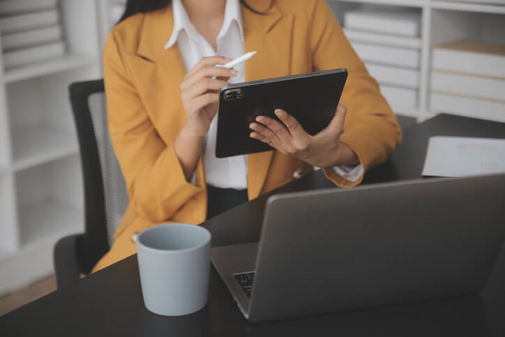 A business finance management training grad using a tablet