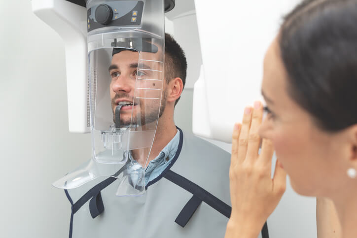 A dental radiography training grad taking an X-ray photo
