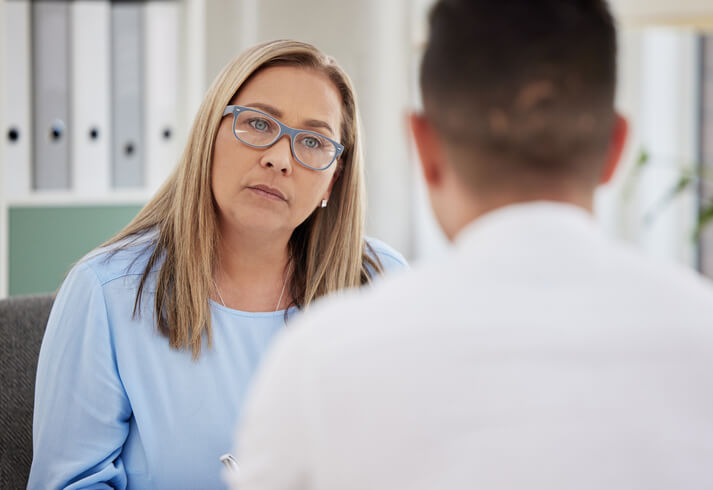 A dedicated community support worker assisting a client in an office.