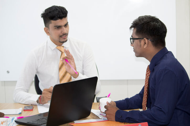 A DCC student discussing a job referral with a mentor after career training