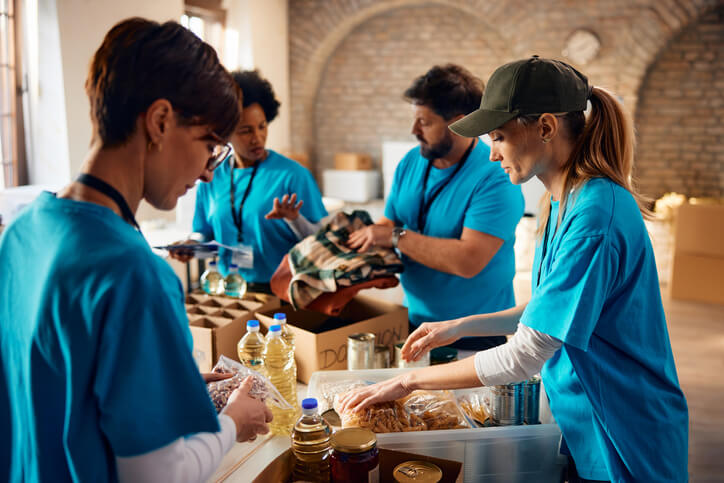 A community support worker group putting together food packs for the public.
