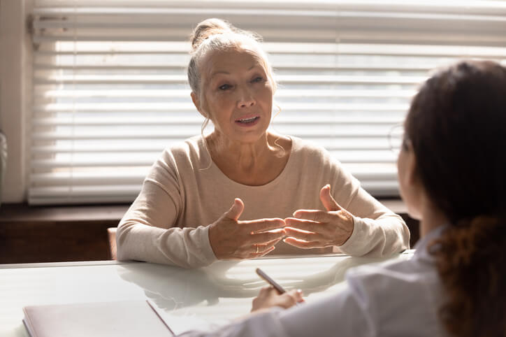 A community support worker assisting an elderly client in Vancouver