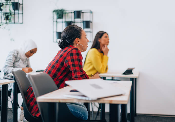A row of students in a classroom during a community support worker course