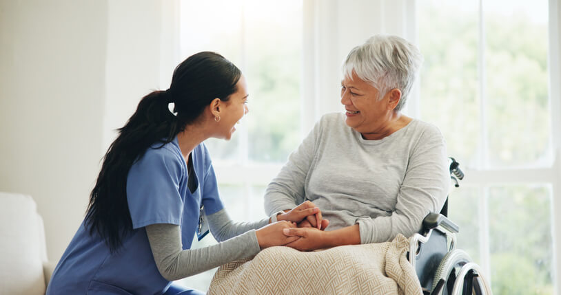 A nurse caring for an elderly patient in a healthcare facility after her practical nurse training
