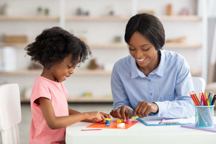An education assistant working with a child one-on-one