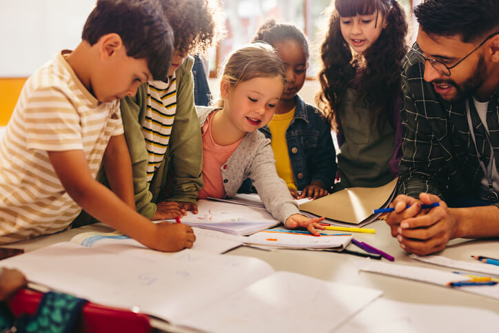 An education assistant helping students in a classroom