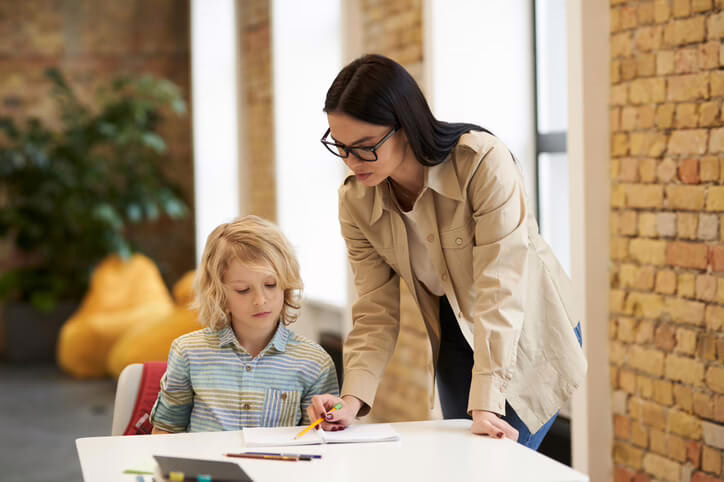 An education assistant working one-on-one with a child