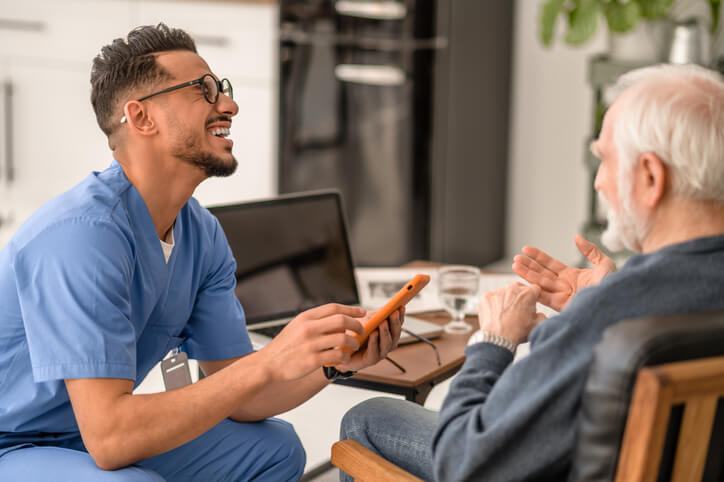 A health care assistant interacting with an elderly client