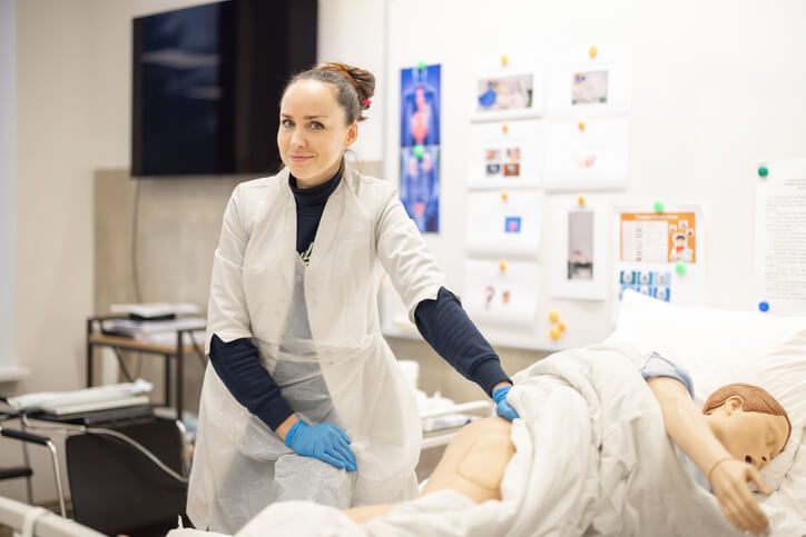 A student in a nursing lab receiving hands-on training