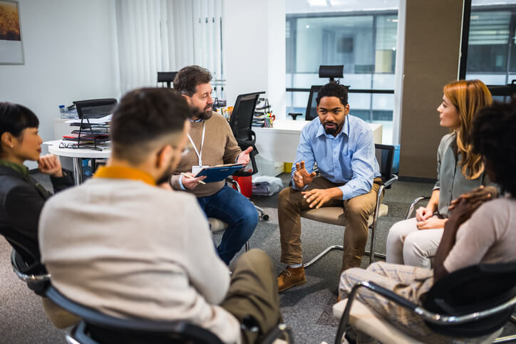 A mental health worker leading a community support group
