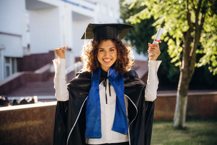 A graduate receiving a certificate after completing her digital marketing course