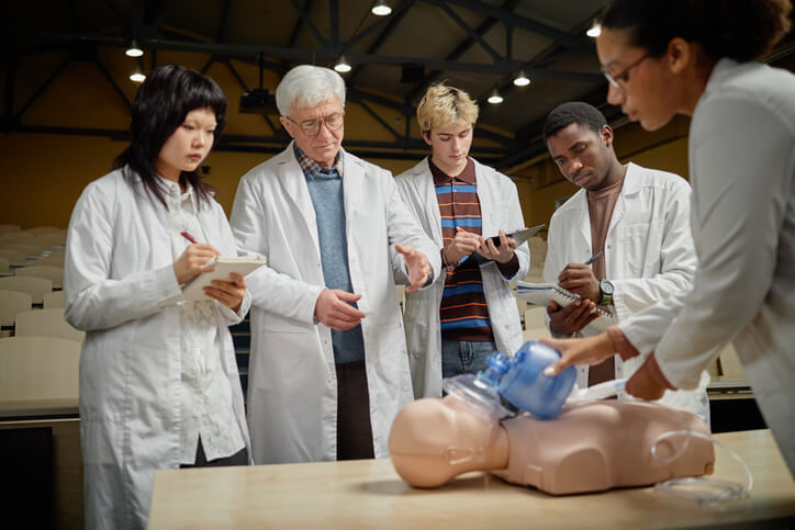 An instructor guiding students during a hands-on HCA training session