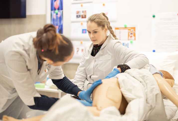 A nursing student practicing clinical skills in a practical lab setting