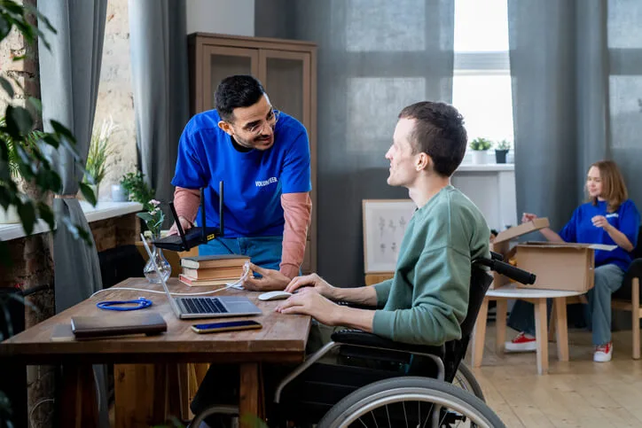 A community support worker assisting a patient in a wheelchair