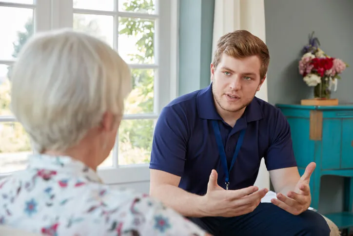 A community support worker in BC assisting a client in a home setting