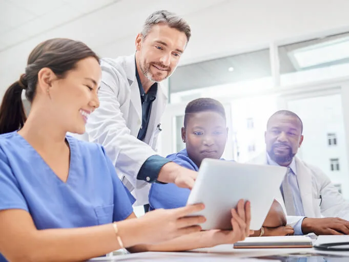 An instructor teaching medical billing software to healthcare management students