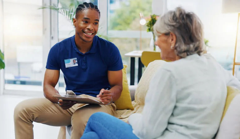 Community Support Worker vs. Social Worker: A community support worker assisting a client with daily living skills