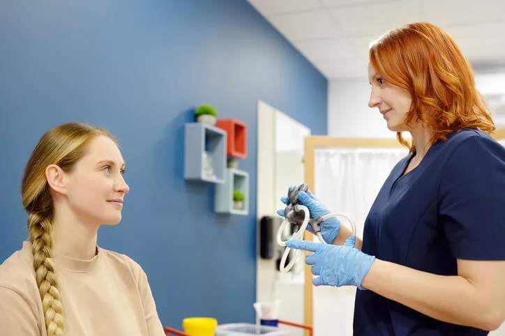 A student applies health care assistant training during hands-on practice placement.