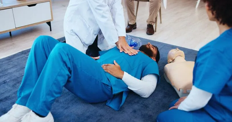 A nursing instructor mentoring practical nursing students during clinical experience in BC.