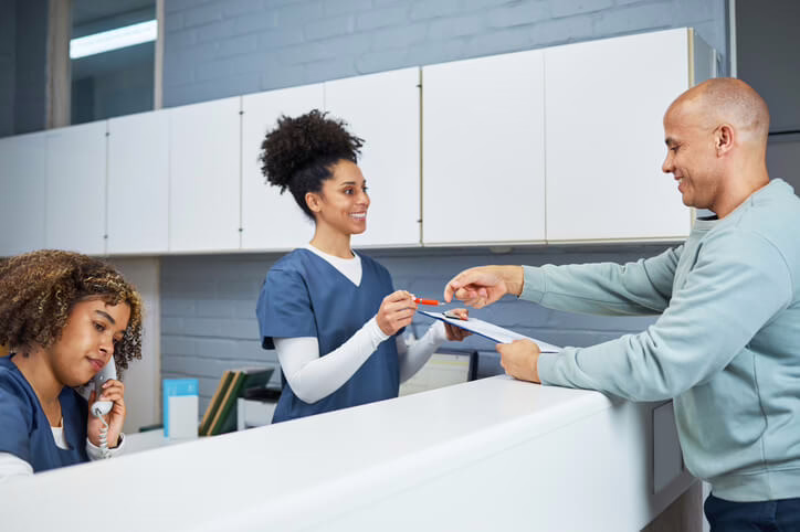 A dental receptionist scheduling appointments and managing patient records
